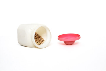 Isolated White Container with Brown Seeds and Pink Lid on White Background, Simple Composition