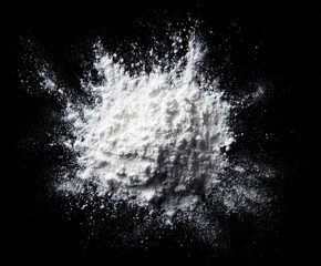White flour explodes outward on black backdrop