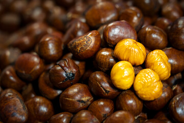 Freshly roasted chestnuts served hot at a street food stall, showcasing a traditional snack popular in local and outdoor markets.