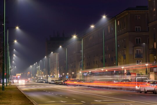 Night city street with car light trails in foggy atmosphere
 - Powered by Adobe