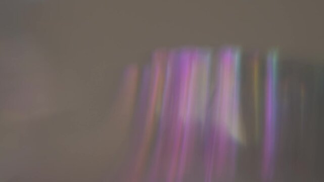 Iridescent light reflections with soft rainbow colors in motion. Perfect for dreamy overlays, abstract visuals, creative backgrounds, and artistic video projects.
