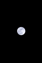 Full Moon Brightly Illuminating the Night Sky with Minimal Clouds Visible