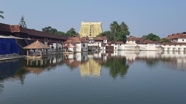 A picturesque lake surrounded by calm waters, with the magnificent Padmanabha Swamy Temple rising elegantly on the shore