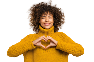 Smiling young woman in yellow sweater making heart shape with hands isolated on white background