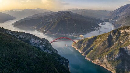 Red Arch Bridge Spanning Yangtze River Through Mountain Gorge at Golden Hour China © Ngo