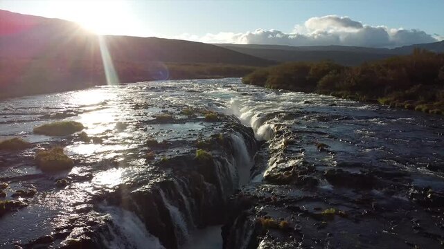 Low Drone Flight Over Br&uacute;arfoss Waterfall with Sun Flare Reverse