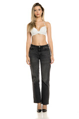 Studio shot of full body woman with long blonde hair wearing white bra and black jeans, standing confidently front view on white background.