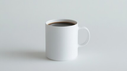 White mug filled with dark coffee on plain background