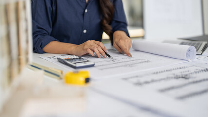 woman engineer works on blueprints in an office design studio
