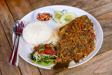 Mujair nyat nyat spicy fried tilapia with rice and side dishes Balinese food