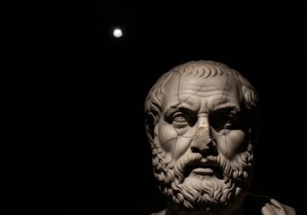 Marble bust of an ancient greek philosopher in a museum with dramatic spotlight illumination