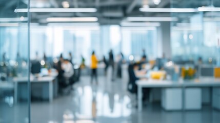 Fototapeta premium Blurred abstract background of a modern open-plan office interior with unrecognizable people working at desks