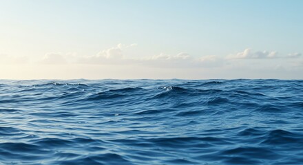 Obraz premium Blue ocean waves under a clear sky