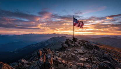American flag atop a mountain peak at sunrise