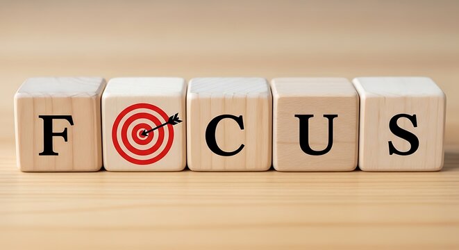 Wooden blocks spell focus with target symbol representing goal achievement success strategy