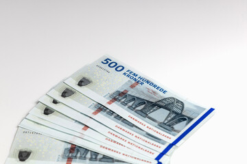 Danish 500 kroner bills stacked on white
