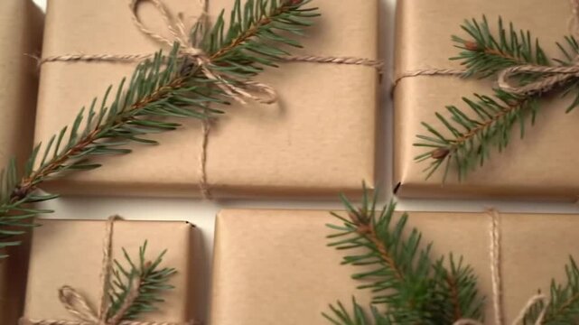 Christmas Presents Wrapped in Brown Paper and Tied with Twine and Adorned with Green Fir Branches