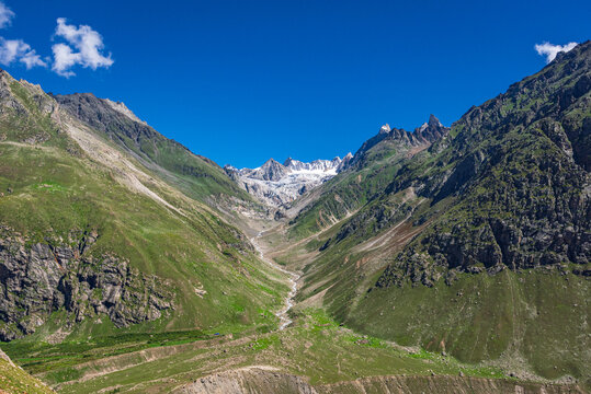 Panoramic view of glacial u-shaped valley having snow cladded peaks, glaciers and moraines  deposited by glacier in high altitude Himalayas mountain region of Himachal Pradesh, India.
