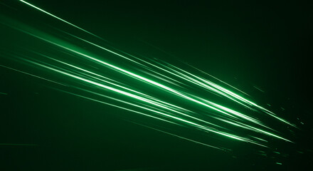 Dynamic green laser beams streaking across a dark background, creating a futuristic abstract effect representing speed and technology