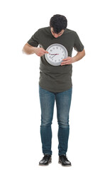 Full length portrait of a young man holding a clock being focused on time management and future planning. Schedule efficiency concept with male isolated on transparent background