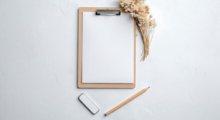 This aesthetic flat lay of an empty notepad and writing tools represents a creative blank slate, ready for new ideas and mindful work.