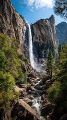 Obraz premium Majestic waterfall cascading down granite cliffs (1)
