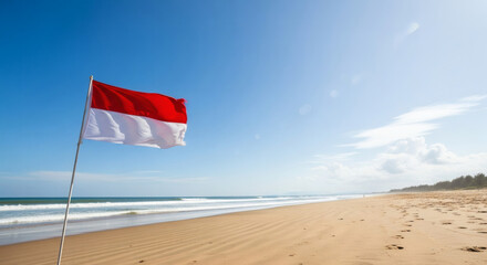Vibrant Indonesian flag waves majestically on a pristine beach under a clear blue sky