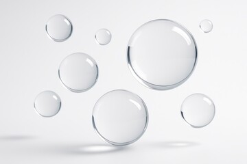 Close up of clear water droplets suspended in the air against a clean white background