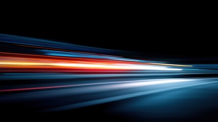Abstract light trails in blue and red against a black background. The image captures the motion and speed of light, creating a dynamic visual effect.