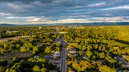 Queensbury, NY, USA - August 27, 2025: Late afternoon aerial view over the Queensbury / Glens Falls area near the southern boundary of the Adirondack Park of of Interstate 87.	