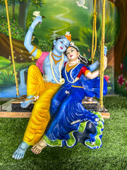 Murthis (statues) in Govardhan Ecovillage, Maharashtra, India. Krishna and Radha on a swing
