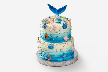 Delicious two-tiered mermaid cake decorated with sea creatures and pearls