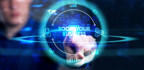 Business, Technology, Internet and network concept. Young businessman shows the word: Boost your...