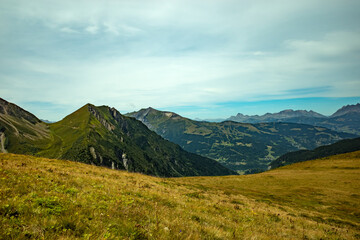 Expansive Alpine Meadow with Distant Mountain Peaks