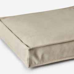 Empty beige dog bed on white background providing comfort and relaxation