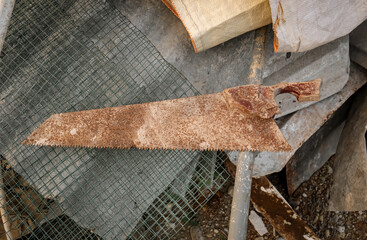 an old and rusty Handsaw on Construction Debris