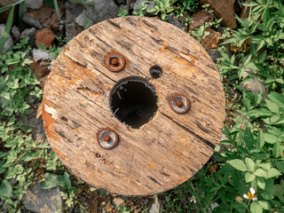 an old Wooden Spool abandoned on bushes