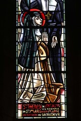 Sacre Coeur de Montmartre basilica, Paris, France. Stained glass. St Teresa inspired by St Margaret devotes herself to the sacred heart