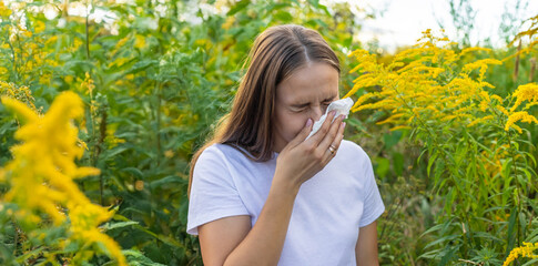 A woman is allergic to ragweed. Nature.