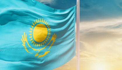 Kazakhstan national flag waving in an amazing sunlight. National flag wavering on mast.
