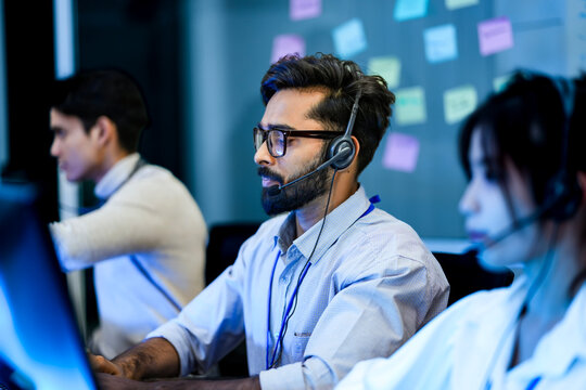 A contact center manager provides on the job training to a new CSR, demonstrating proper use of the CRM and knowledge base to improve her First-Call Resolution FCR metrics.