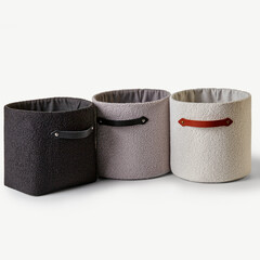 Stylish boucle storage baskets with leather handles on white background