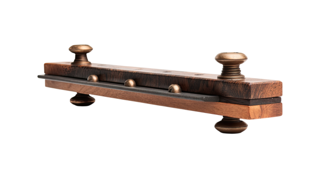 Wooden string instrument bridge, dark and light brown wood, brass accents