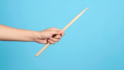 Hand Holding Drumstick on Blue Background