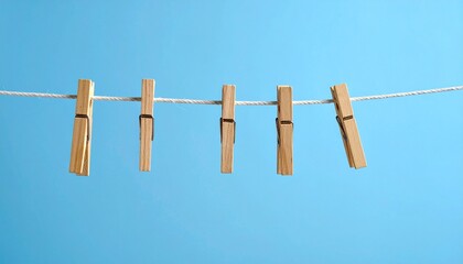 Wooden Clothespins on a Blue Clothesline