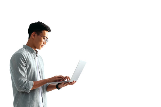 Standing Southeast Asian Man Typing on Laptop with Focused Expression, Side-Angled Office Style, Isolated on Transparent Background (2)