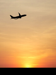  Soaring Flight at Sunset: An airplane silhouetted against a vibrant sunset sky, symbolizing travel, adventure, and the promise of journeys.