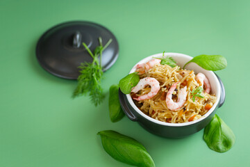 Serving rice with shrimps in ceramic dishes on the background