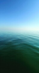 Obraz premium Still, Calm Water Meets Clear Sky