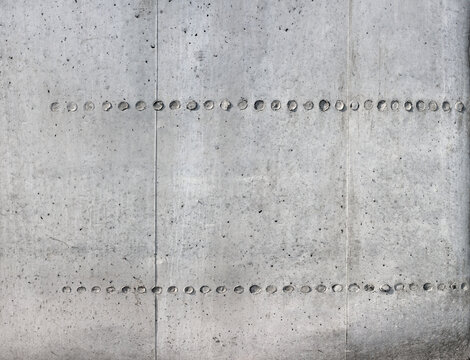 A raw, untreated exposed concrete surface with a slightly irregular texture.